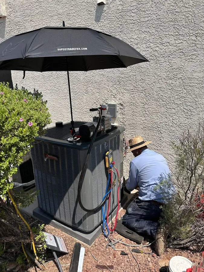 HVAC technician performing outdoor AC maintenance in Mattapoisett